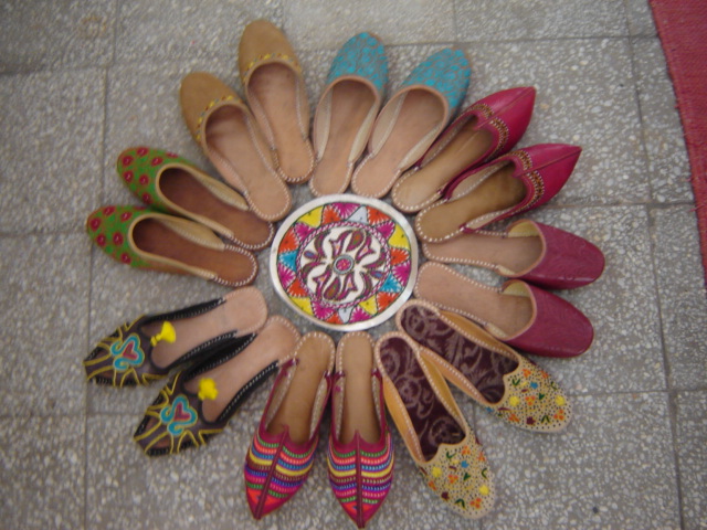 Colorful handmade juttis arranged in a circle